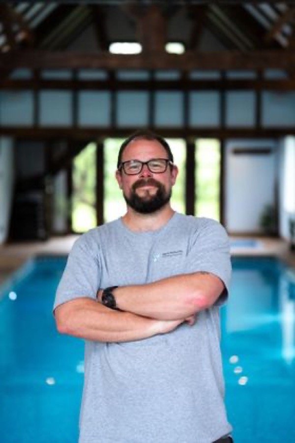 Aqua Perfection owner in front of a pool